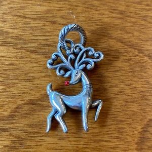 Silver colored reindeer charm.